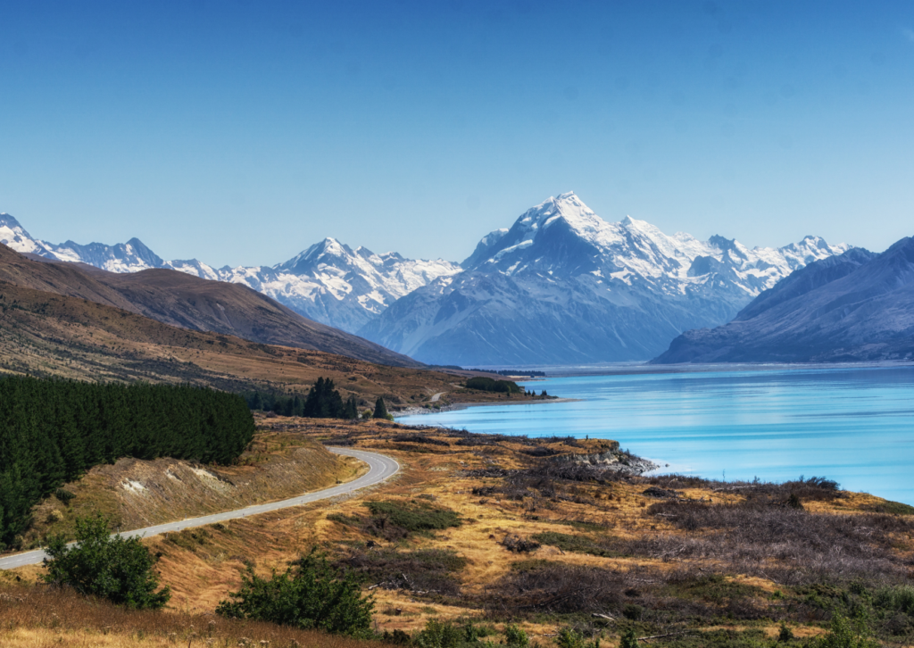 Picture of turciouse water against snowy mountain peaks in new zealand